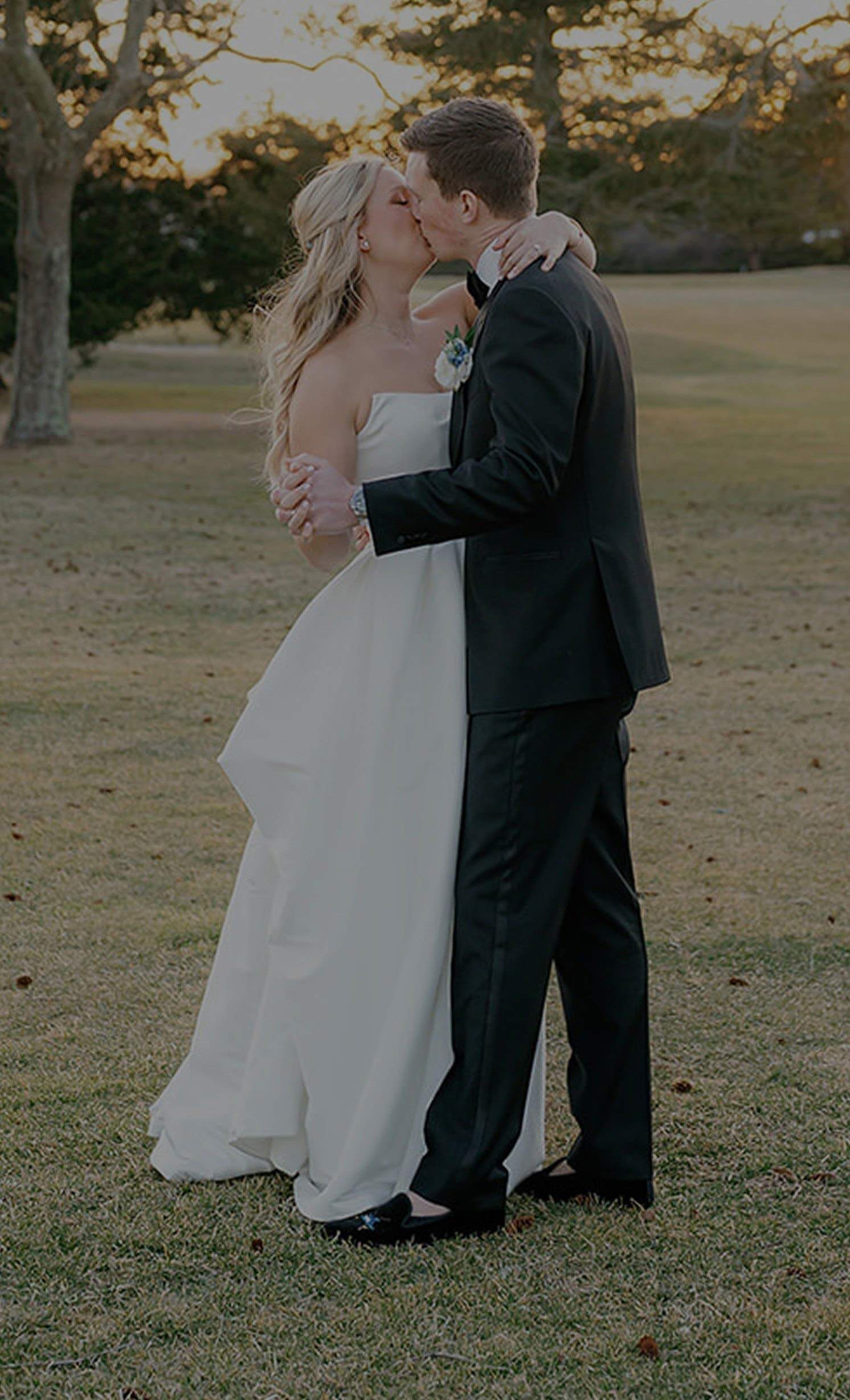 Сouple wearing a white gown and a black suit. Mobile-image