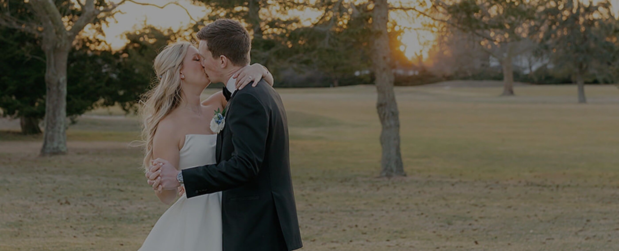 Сouple wearing a white gown and a black suit